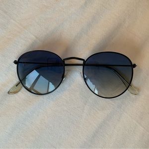 Vintage black sunglasses with blue-tinted lens